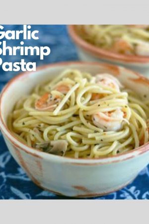 Tan bowl with spaghetti topped with garlic shrimp