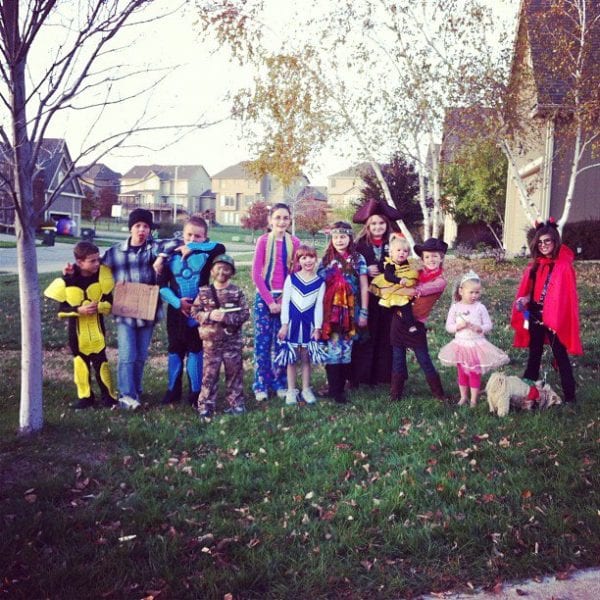 a group of kids dressed up for Halloween in a yard in Kansas