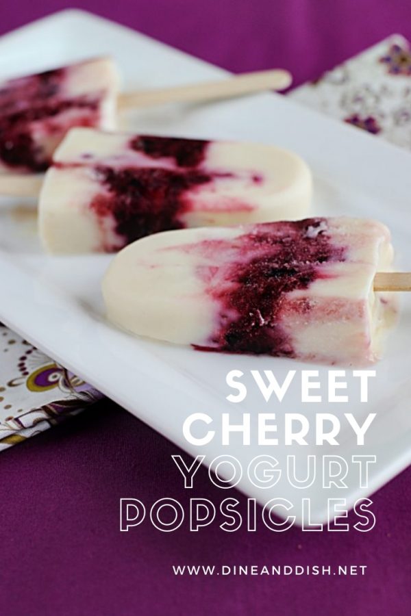 Sweet Cherry Yogurt Popsicles recipe on a plate with cherry swirls