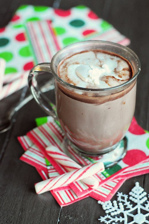 Cup of hot chocolate on festive napkins with peppermint sticks