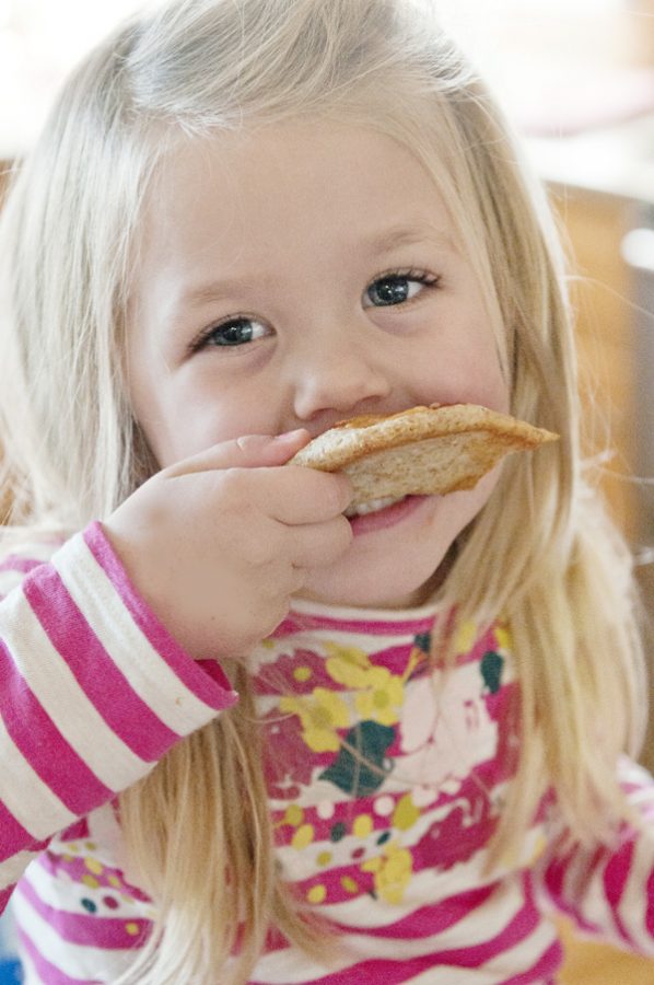 Little girl eating pizza