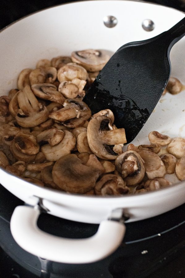 Skillet of mushrooms being sauteed 