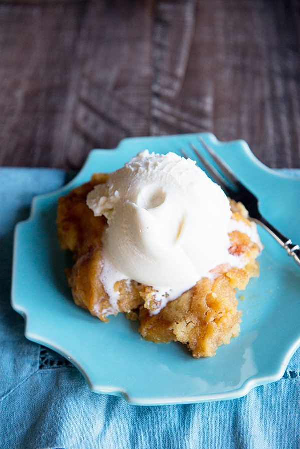A slow cooker peach dessert recipe that is super simple to make from dineanddish.net