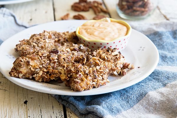 I love these Pecan and Pretzel Crusted Baked Chicken Tenders! Recipe on dineanddish.net.