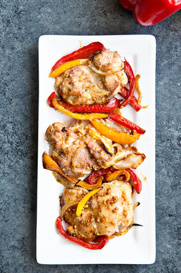 Baked Boneless Chicken Thighs with peppers and onions. This recipe is great for a busy weeknight because it can be on your table in 30 minutes or less!