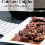 An instant pot with chicken thighs in red wine sauce on a white platter.