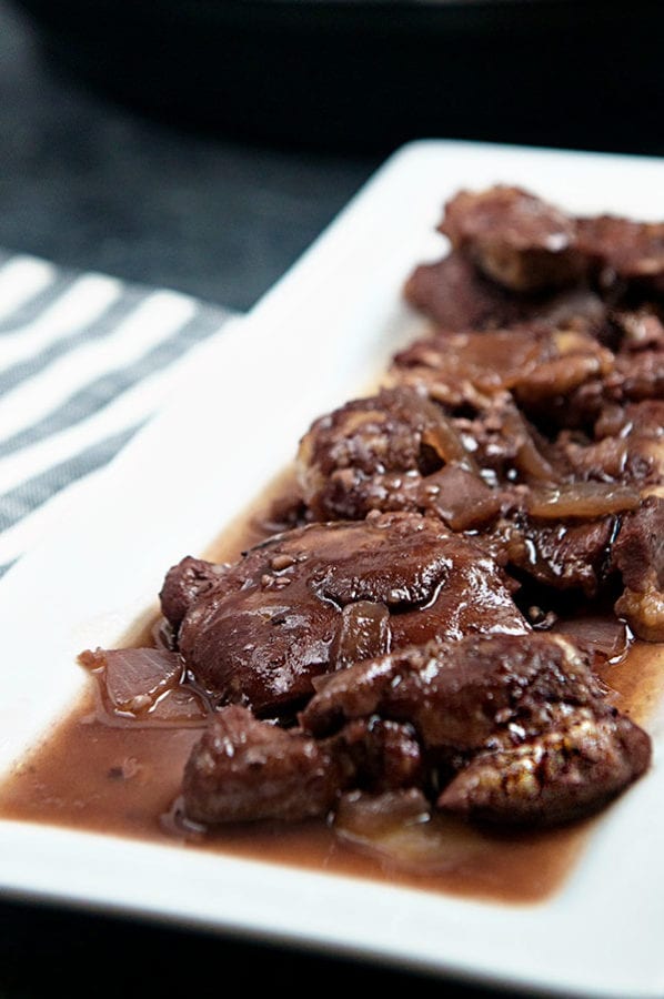 Instant Pot Chicken Thighs on a white plate with a rich red wine sauce