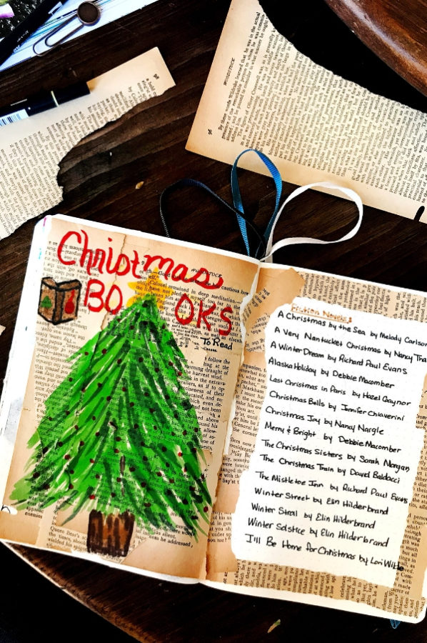 An open notebook with a Christmas tree drawing and a bullet journal spread of Christmas Books to read