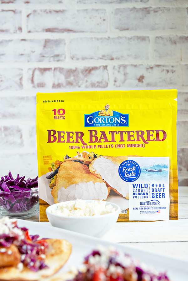 Yellow Bag of Gorton's Beer Battered Fish Fillets in front of a white brick background