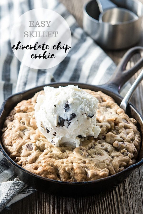 chocolate chip cookie in a cast iron skillet topped with ice cream