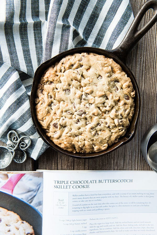 Recipe page with skillet cookie recipe and cast iron pan with chocolate chip cookie