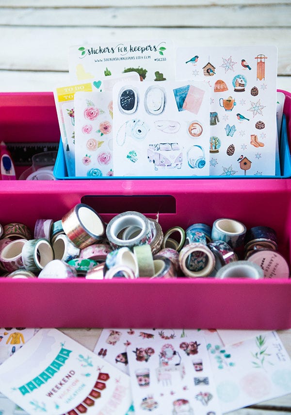 Pink bucket full of washi tape and cullet journal stickers