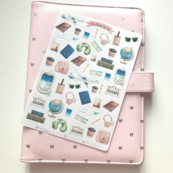 Travel sticker sheet on a pink notebook