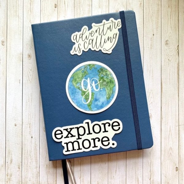 Blue journal with 3 bullet journal quote stickers on the front