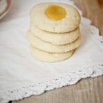Lemon Curd Thumbprint Cookies on a cream background
