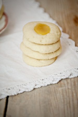 Lemon Curd Thumbprint Cookies on a cream background