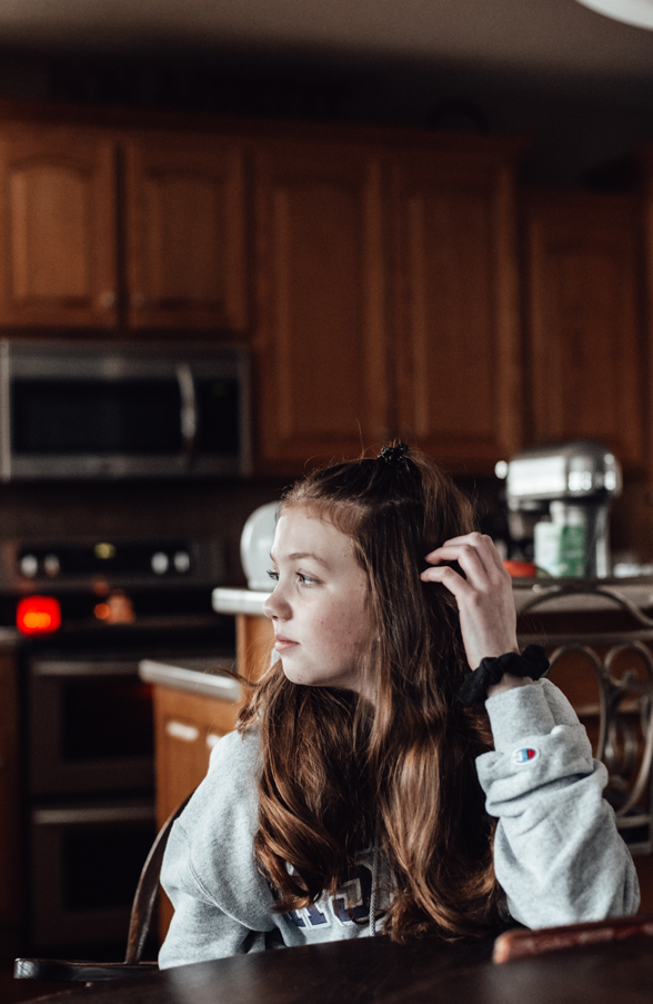 Girl sitting in the kitchen looking out the window Project 365