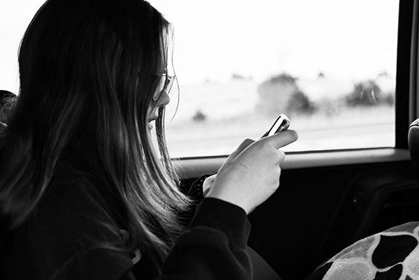 Girl on phone riding in the car