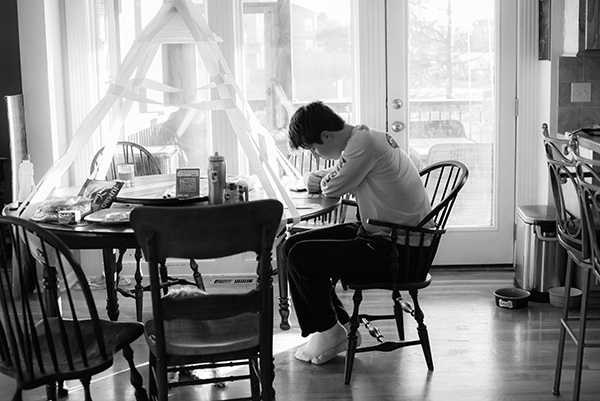 black and white photo of man sitting at a table