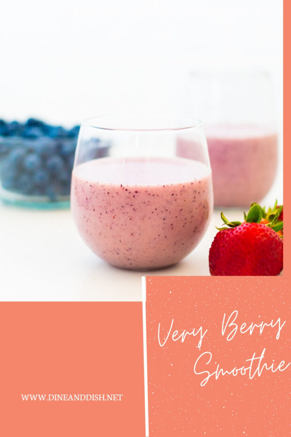 White background with 2 pink smoothies and strawberries and blueberries
