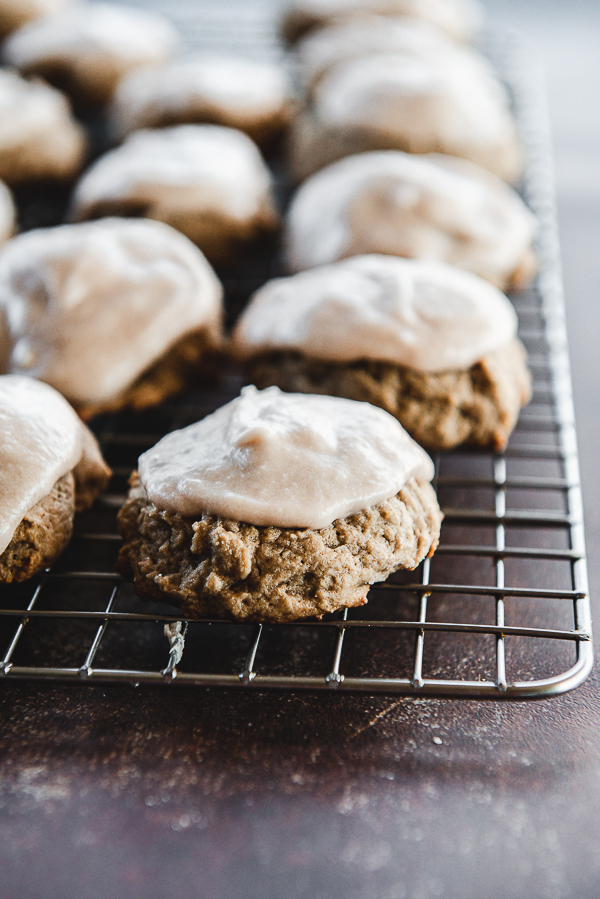 image is a wire cooling rack lined with chocolate drop cookies